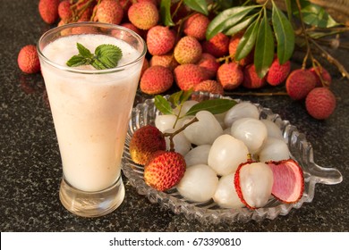 Litchi juice in a glass. Fresh juicy lychee fruit on a glass plate. Organic leechee sweet fruit. Organic fruit concept. Exotic tropical litschi berry. Peeled lychee fruit.Selective focus.