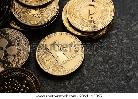Litecoin cryptocurrency surrounded by various golden cryptocurrencies