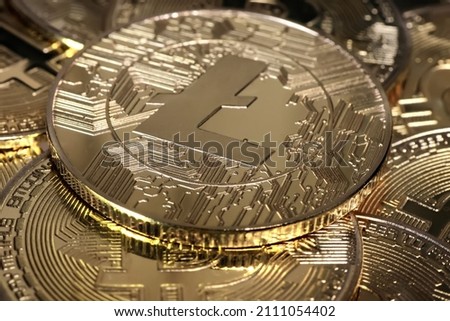 Litecoin LTC coin on bitcoins background, cryptocurrency investing concept.