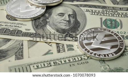 Litecoin LTC coins rotating on dollars bills