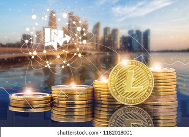 Litecoin LTC and cryptocurrency investing concept - Physical Litecoin coins with city background and exchange market trading price chart. Blockchain and financial technology.