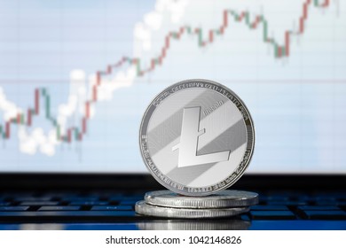 LITECOIN (LTC) cryptocurrency; physical concept litecoin on the background of the chart