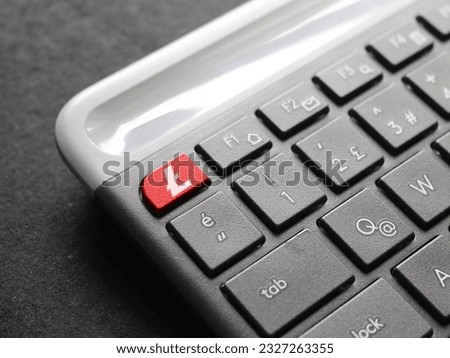 Litecoin (ltc) icon over the red ESC key on the keyboard.