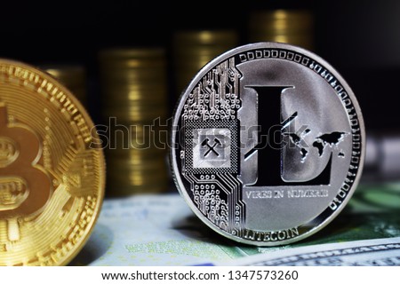 Litecoin LTC is surrounded by a money background. Concept of cryptocurrency.