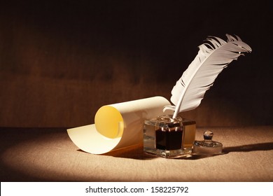 Literature Symbol. Old inkstand near scroll on canvas background