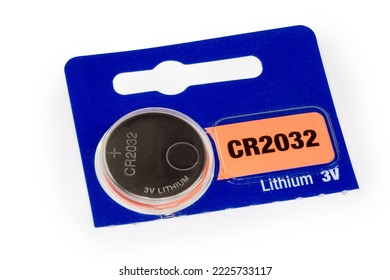 Lithium button battery CR2032 type with voltage and polarity designation in the commercial packaging on a white background close-up  - Shutterstock ID 2225733117