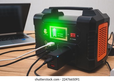 lithium Portable Power Station is charging laptop smartphonesPower banks and other gadgets.Modern, information technology. Control panel. close up.