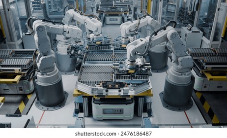 Lithium-Ion EV Battery Pack Assembly Process. Electric Car Manufacturing Inside Automotive Factory. Row of Industrial Robotic Arms at Automated Production Line at Bright Modern Factory.  - Powered by Shutterstock