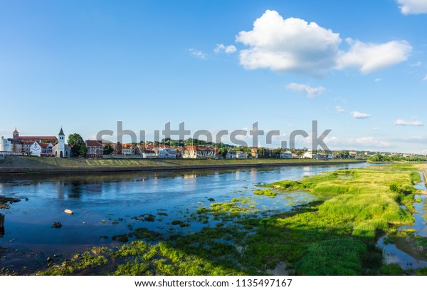 Lithuania, Kaunas city buildings reflecting in\
water of river XXL\
panorama
