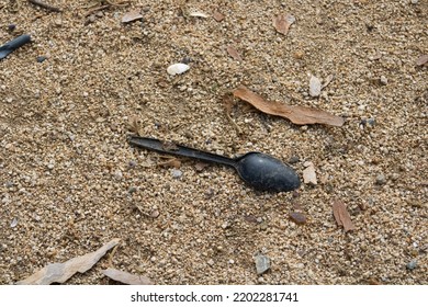 Litter Black Plastic Spoon In Dirt