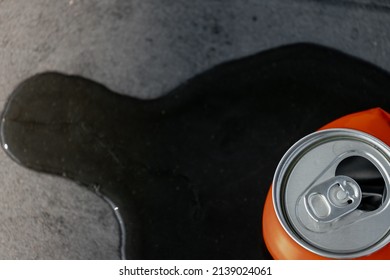 Littering campaign and recycling concept, Leaking water on the side of an aluminium can, Top view of opened can drink with floor as background, Save the world and stop global warming, Free copy space.