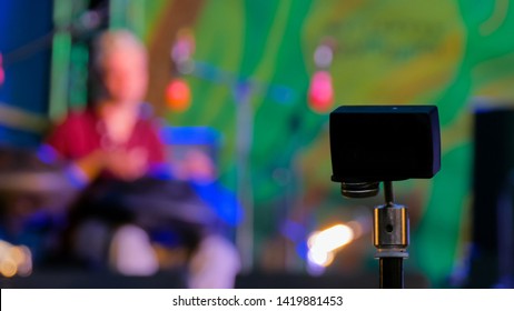 Little action video camera recording ethnic open air concert. Man with tank drum or hang on blurry abstract bokeh background - Powered by Shutterstock