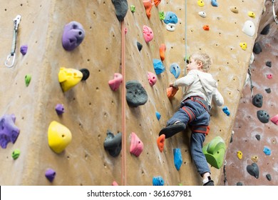 Little Active Boy Rock Climbing At Indoor Gym