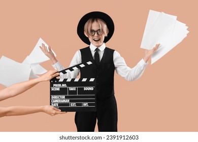 Little actor with film script on beige background - Powered by Shutterstock