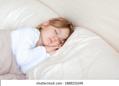 Little Adorable Blonde Girl In Cotton Pajamas Closed Eyes Lying In Bed Sleeping On Comfortable Pillow Under Blanket, Good Night Sweet Dreams Health Care, Real Life Moment Concept