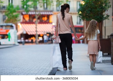 Little adorable girl with mother on shopping in Paris outdoors