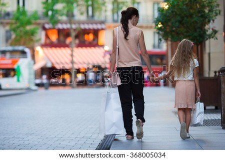 Little adorable girl with mother on shopping in Paris outdoors