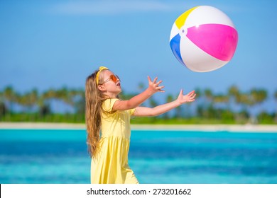 Little Adorable Girl Playing On Beach With Ball