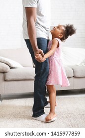 Little African American Girl Dancing With Father, Standing On Her Daddy's Feet, Looking At Him And Smiling