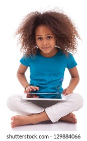 Little African Asian Girl Using A Tablet  Pc, Isolated On White Background