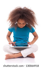 Little African Asian Girl Using A Tablet  Pc, Isolated On White Background