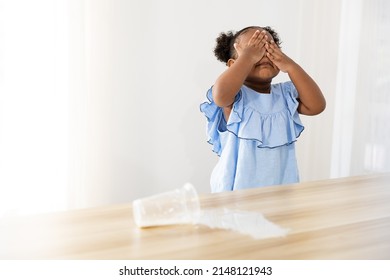 Little African Girl Close Her Face Because She Spilling Milk On The Table