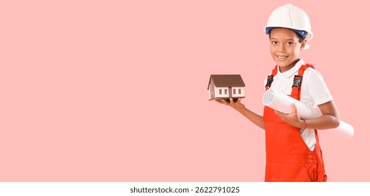 Little African-American architect with house model and blueprint on pink background with space for text