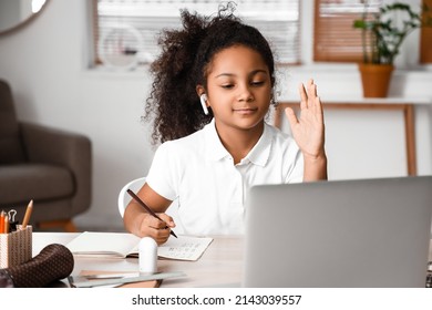 Little African-American Girl Asking Her Online Tutor Question At Home