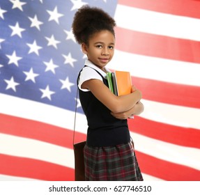 Little African-American girl with books on USA flag background - Powered by Shutterstock