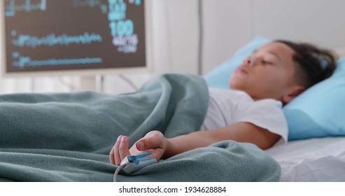 Little afro boy sleeping in hospital bed attached to monitors. Portrait of unconscious preteen kid patient with oximeter on finger lying in bed in intensive care unit - Powered by Shutterstock