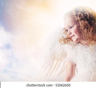 Little angel girl against sunny sky