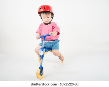 Little Asain Baby Toddler Ride A Tricycle Bike On White Background