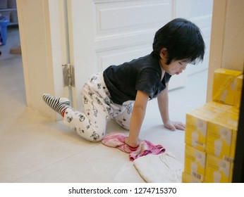 Little Asian Baby Girl Cleaning Her Own Mess, Body Powder, On The House Floor - Allowing Baby To Clean Up Their Own Mess To Develop Their Sense Of Responsibility