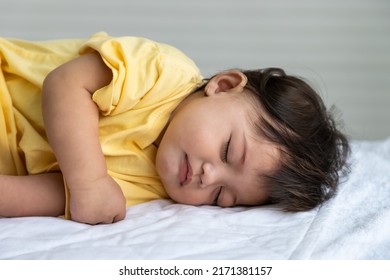 Little Asian Baby Girl Lying Down Sleeping On Bed At Home. Newborn Child Relaxing In Bed. Nursery For Young Children.