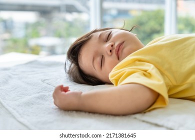 Little Asian Baby Girl Lying Down Sleeping On Bed At Home. Newborn Child Relaxing In Bed. Nursery For Young Children.