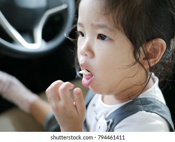 Little Asian Baby Girl, Two Years Old, Is Choking While Eating A Piece Of Apple