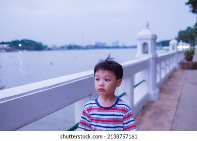Little asian boy with Chao Phraya river, Famous water landmark travel Bangkok Thailand. Soft focus. copy space.