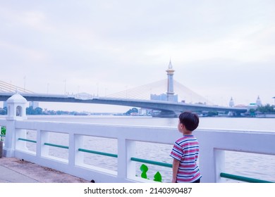 Little asian boy with Chao Phraya river, Famous water landmark travel Bangkok Thailand. Soft focus. copy space.