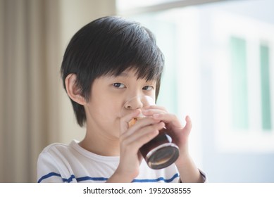 Little Asian Boy Drinking Soft Drink Cola Soda