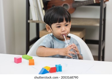 Little Asian Boy Drinking Water From Bottle.