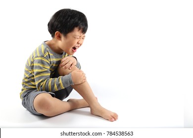 A Little Asian Boy Have Injured His Leg And Suffering Knee Pain Sitting On The Floor.