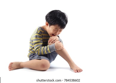 A Little Asian Boy Have Injured His Leg And Suffering Knee Pain Sitting On The Floor.