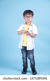 Little Asian Boy Learning Chemical In Science With White Blouse Coat, Isolated On Blue Background