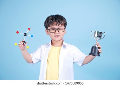 Little Asian Boy Learning Chemical In Science With White Blouse Coat, Isolated On Blue Background