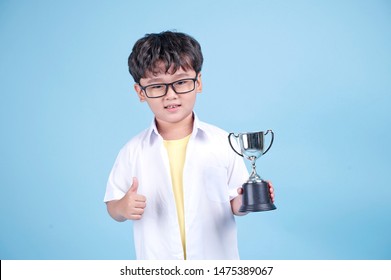 Little Asian Boy Learning Chemical In Science With White Blouse Coat, Isolated On Blue Background