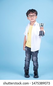 Little Asian Boy Learning Chemical In Science With White Blouse Coat, Isolated On Blue Background