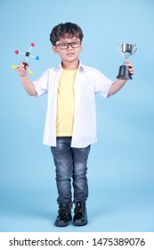 Little Asian Boy Learning Chemical In Science With White Blouse Coat, Isolated On Blue Background