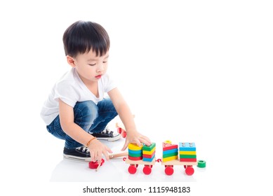 Little asian boy playing toy on the floor over white background