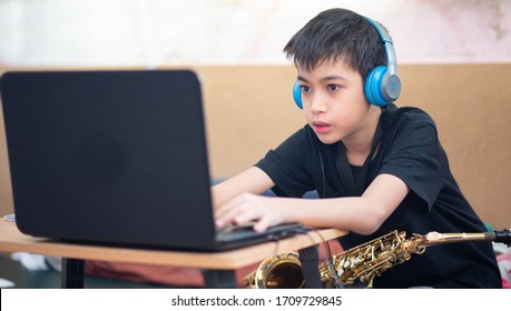 Little Asian Boy Study Saxophone Instument Music Online At Home 