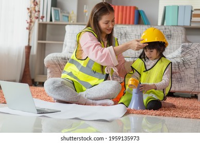 Little Asian Child Engineer In Yellow Helmet Shouting By Megaphone With Her Mother, Education And Occupation Concept